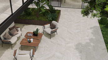 Stone look porcelain pavers used in a modern outdoor living area with seating and garden landscaping